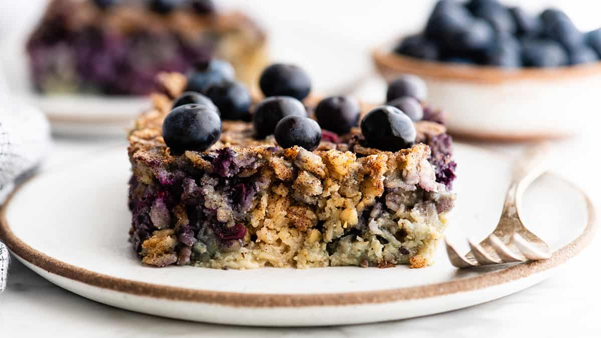 front view of a piece of Blueberry Baked Oatmeal on a plate with a fork