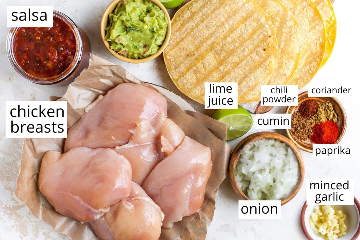 overhead view of the labeled ingredients in this crockpot chicken tacos recipe