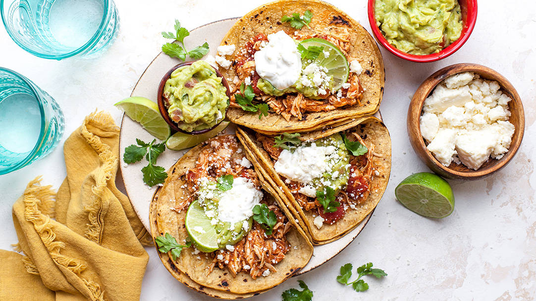 overhead view of three crockpot chicken tacos on a plate 