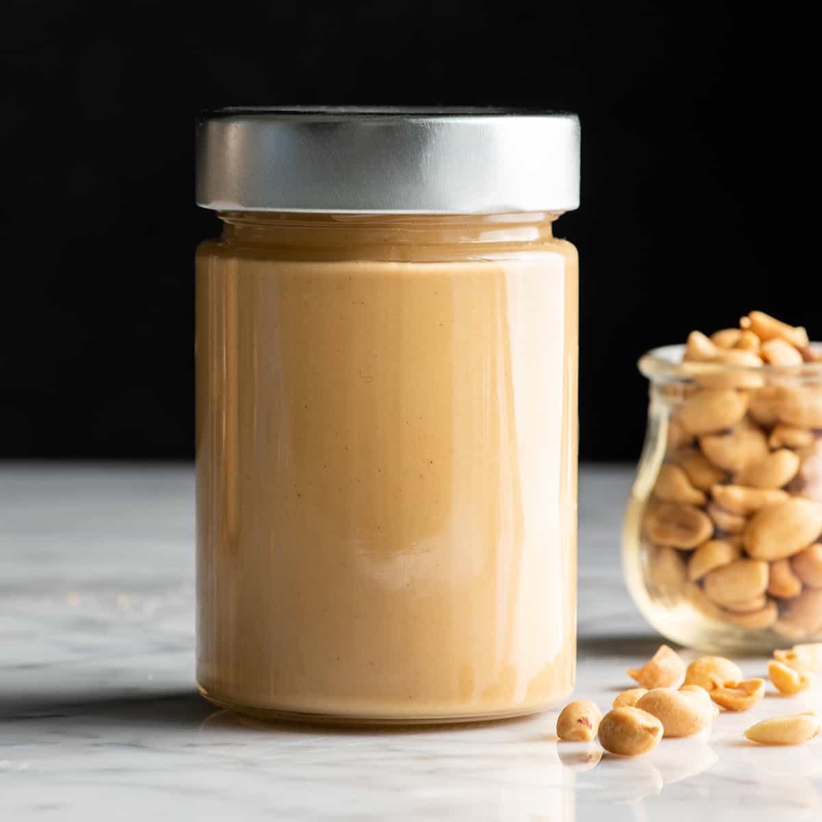 front view of a glass jar of homemade peanut butter