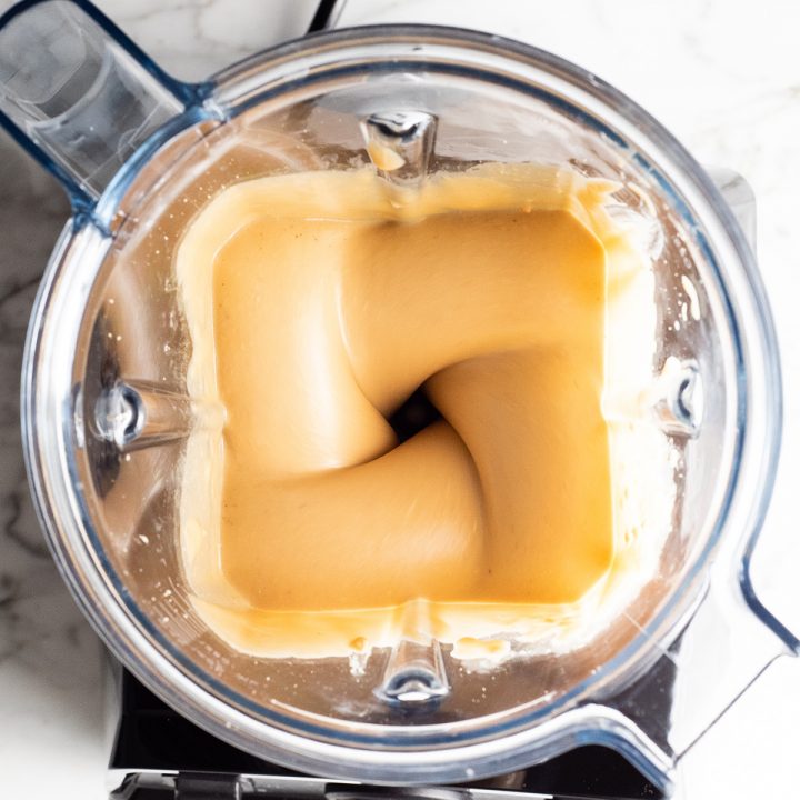 overhead photo showing how to make peanut butter in a blender (vitamix)