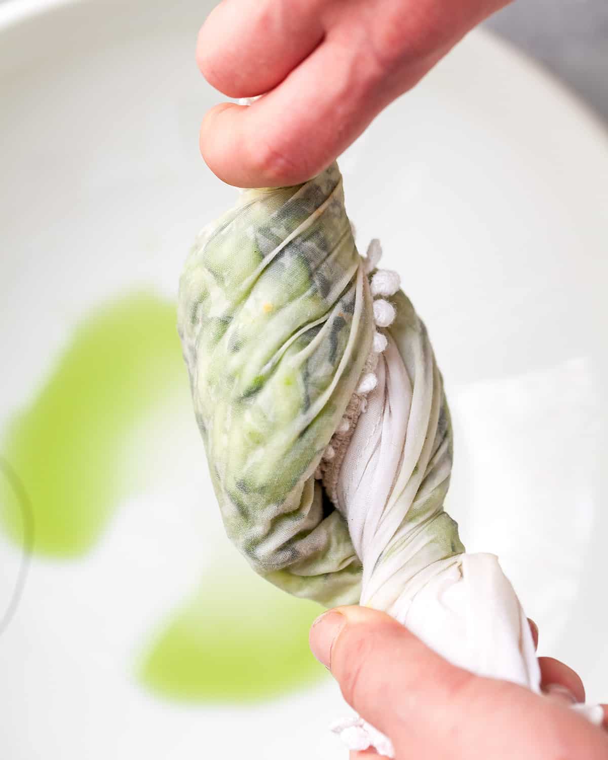 How to Make Tzatziki Sauce - ringing water out of cucumber in a towel