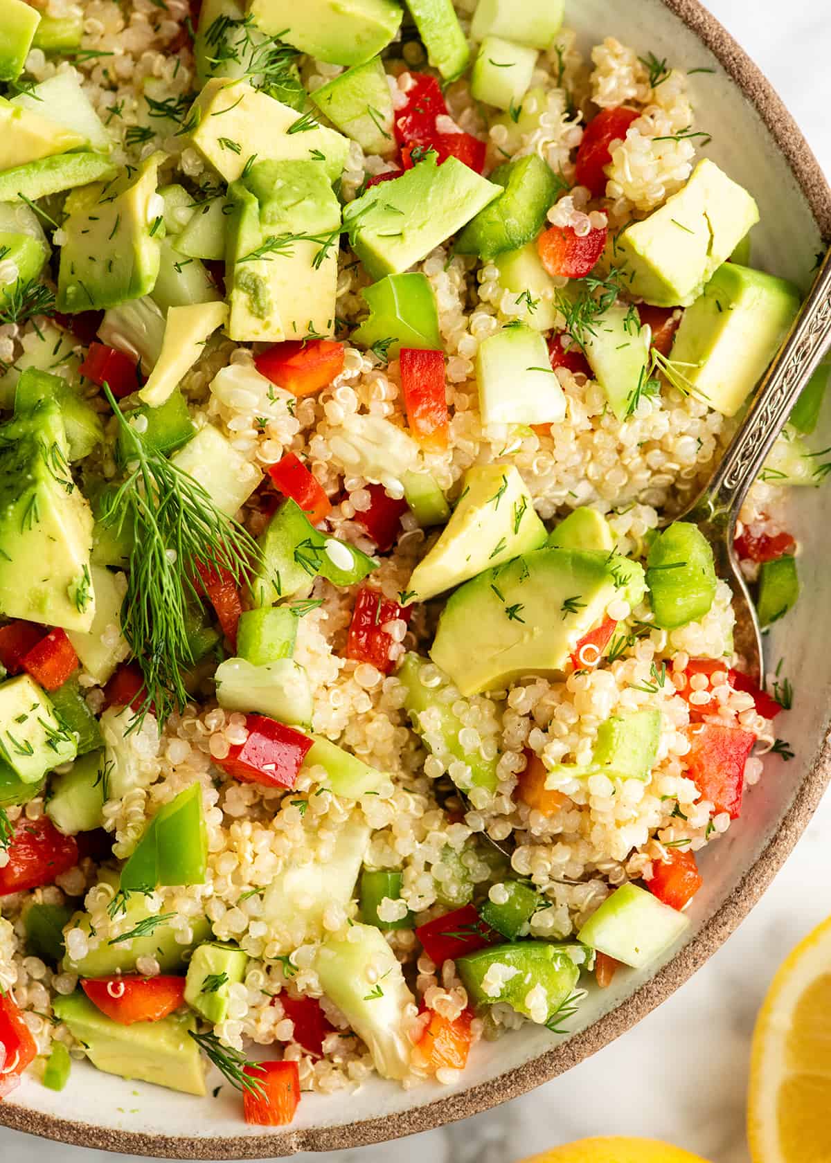overhead view of a large bowl of quinoa salad with a spoon 