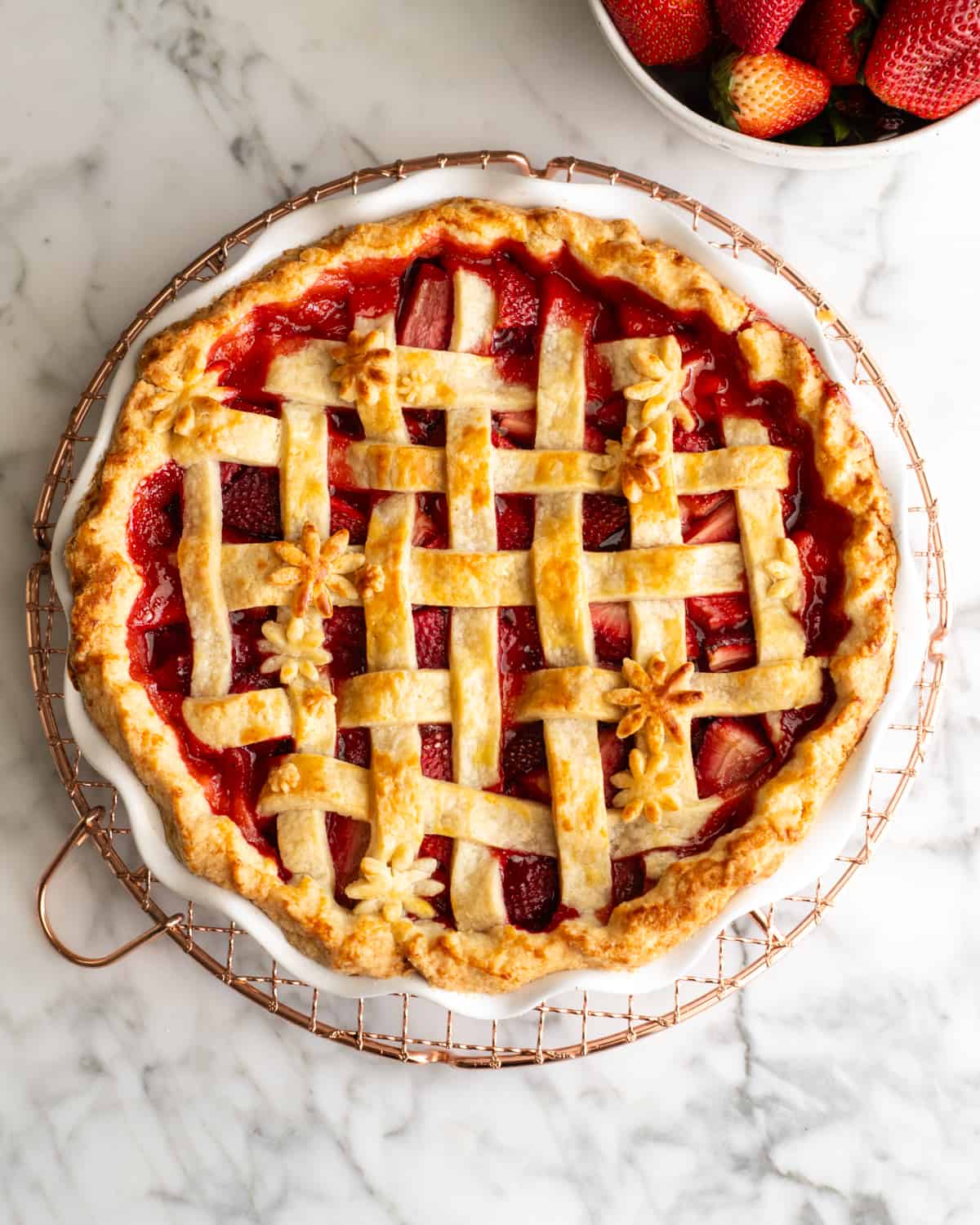 baked strawberry pie on a cooling rack after baking
