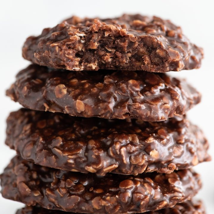 stack of four no bake cookies, top one has a bite taken out of it