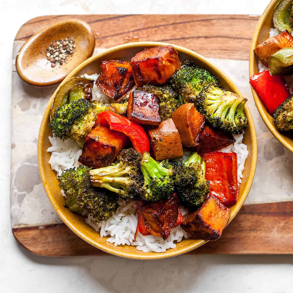A bowl of roasted Vegetables over rice.