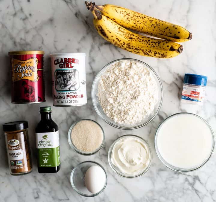 Light & fluffy with hints of cinnamon and vanilla and tons of banana flavor, this is truly the best banana pancake recipe! These banana pancakes are easy to make with no mixer required, and they're the perfect Saturday morning breakfast or brunch. overhead view of the ingredients in this banana pancakes recipe