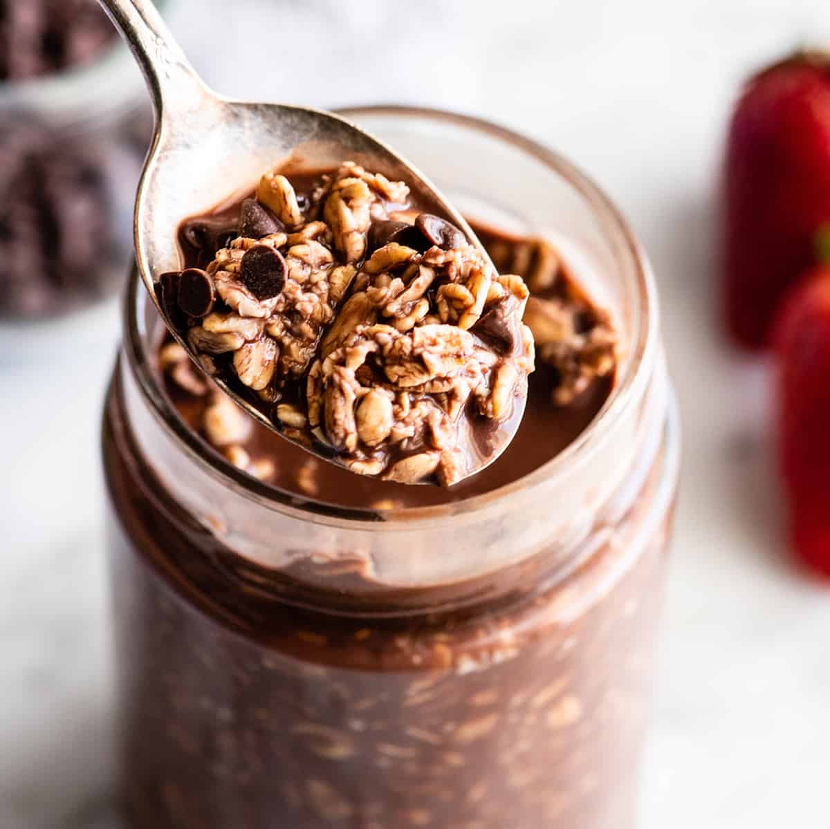 Front view of a spoon of chocolate overnight oats