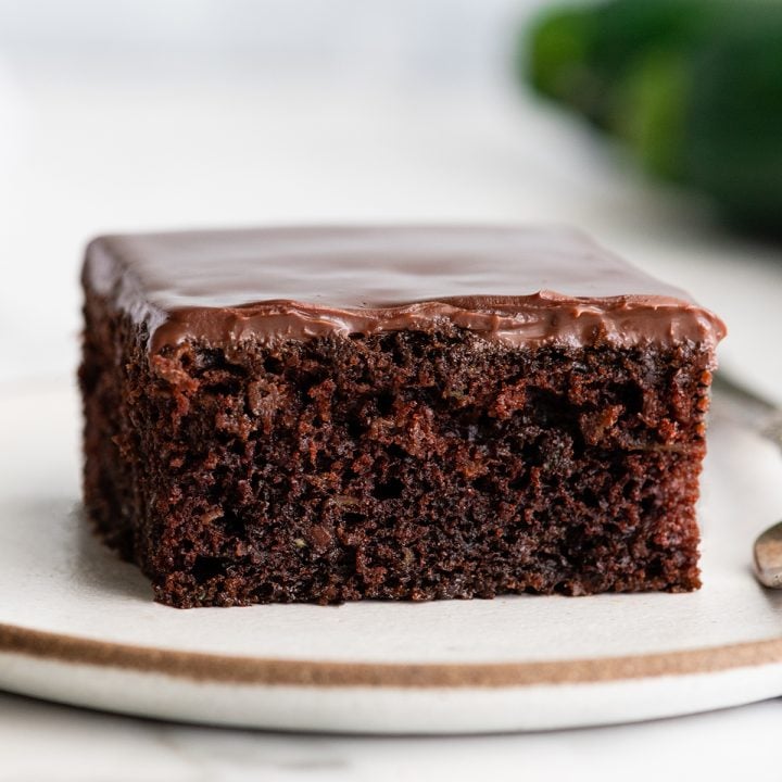 front view of a piece of chocolate zucchini cake with chocolate ganache
