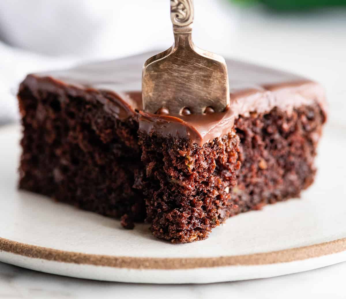 front view of a fork taking a bite of chocolate zucchini cake