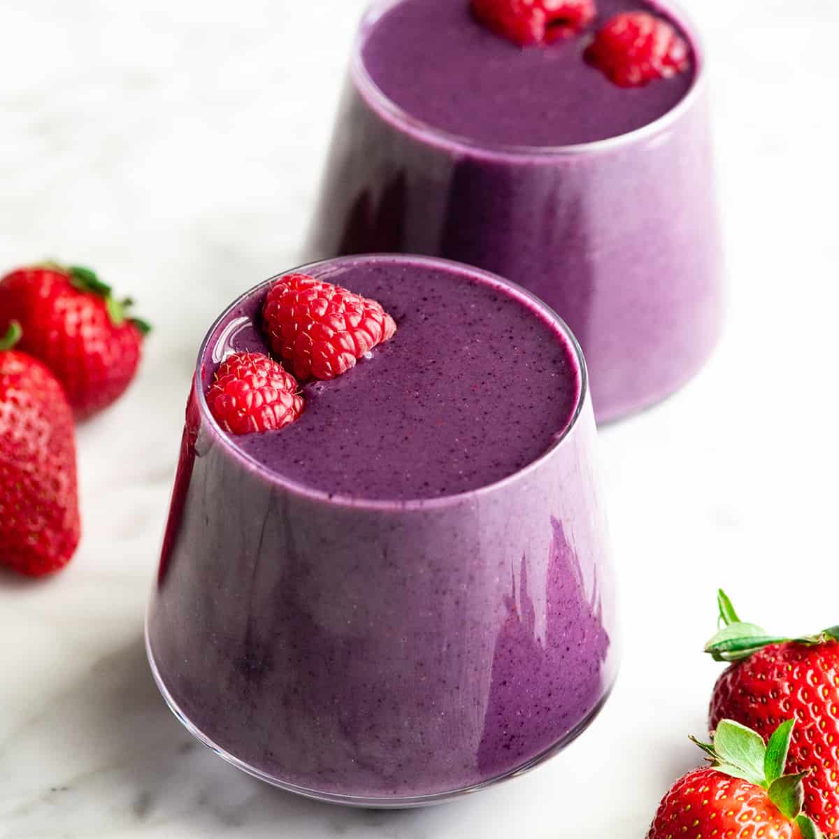 two mixed berry smoothies in glass cups
