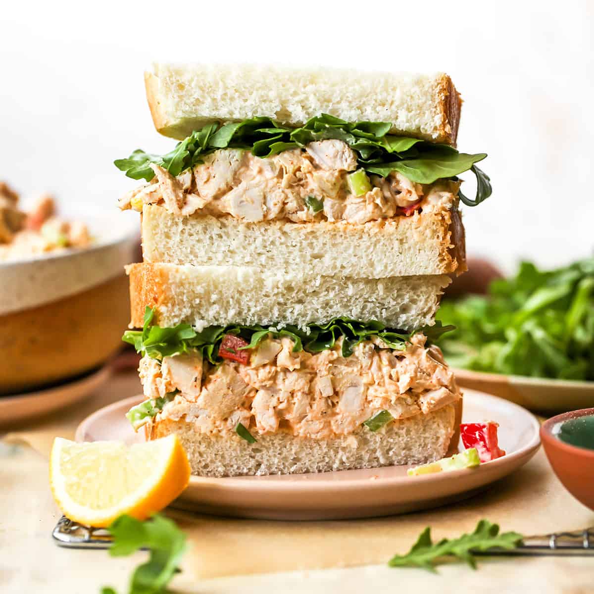 front view of a two halves of a chicken salad sandwich stacked