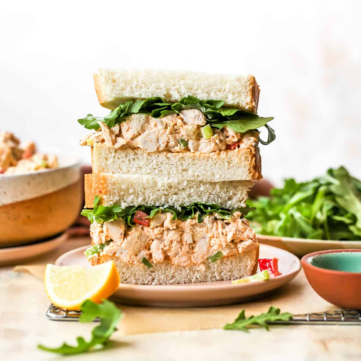 front view of two halves of a chicken salad sandwich stacked