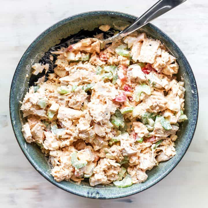 overhead photo of chicken salad in a bowl with a spoon
