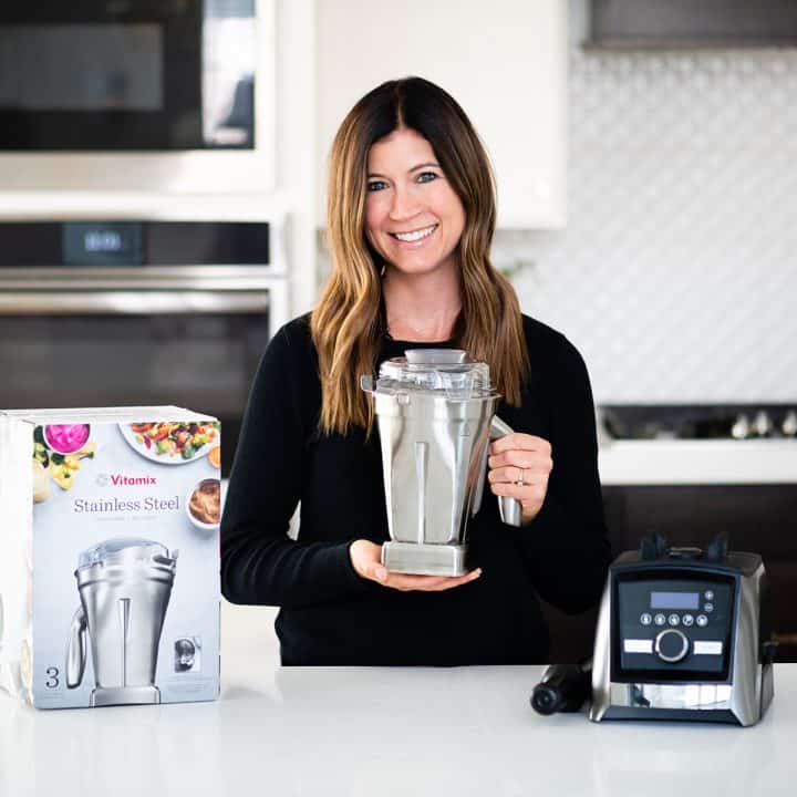 Woman holding the Vitamix stainless steel container