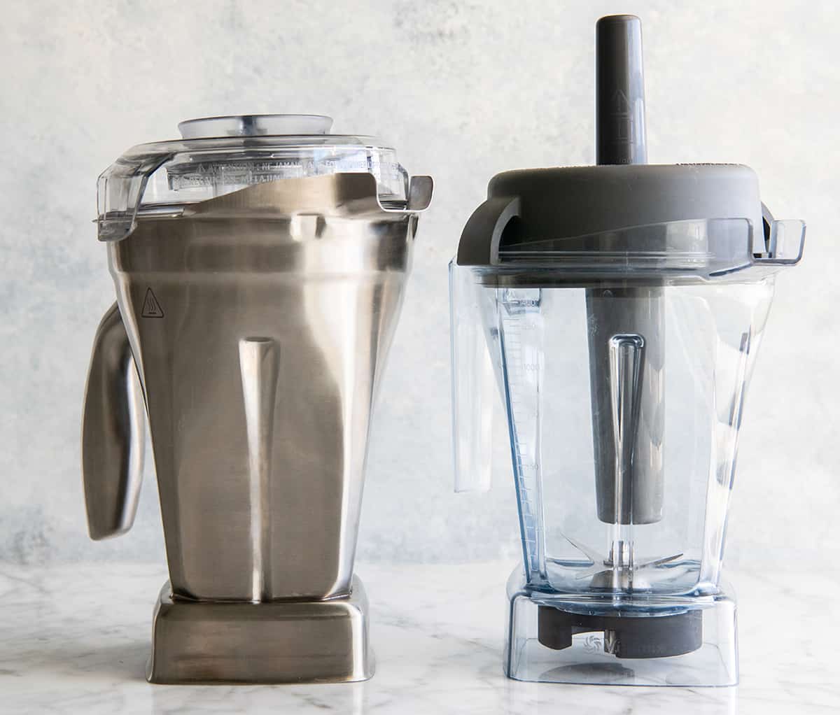 Vitamix stainless steel container next to 48 oz Vitamix container