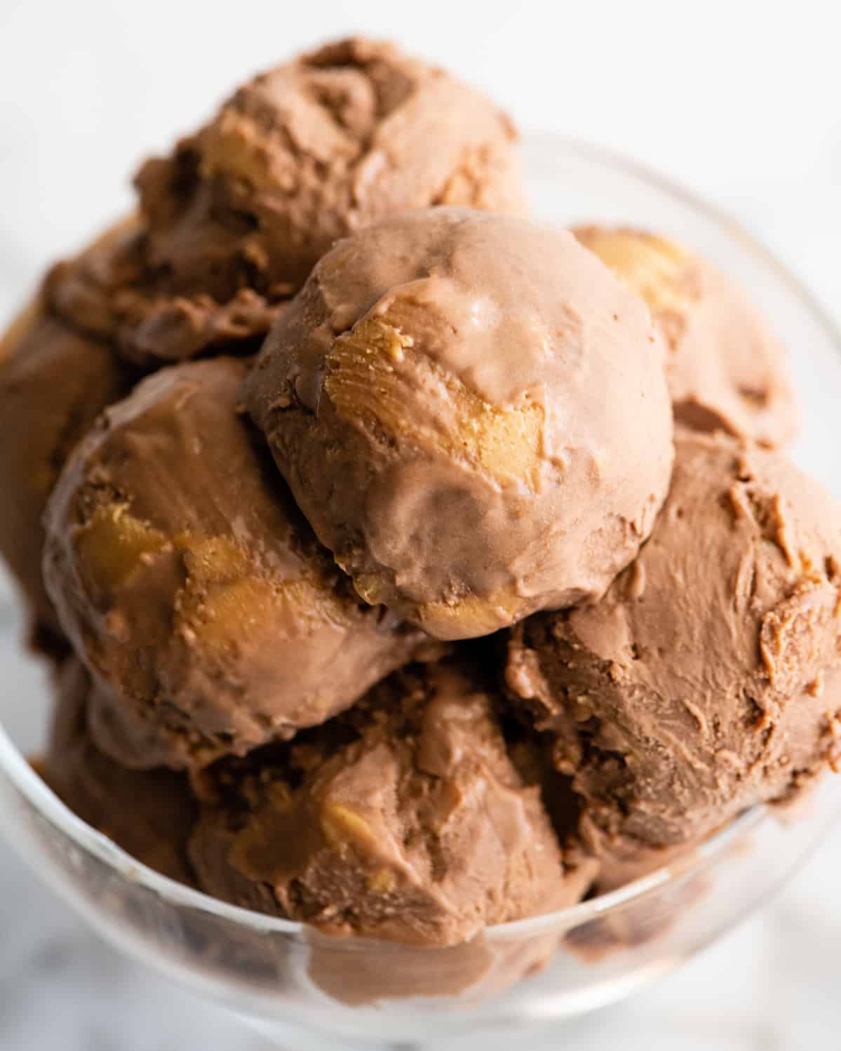 up close photo of scoops of Homemade Chocolate Peanut Butter Ice Cream in a glass dish