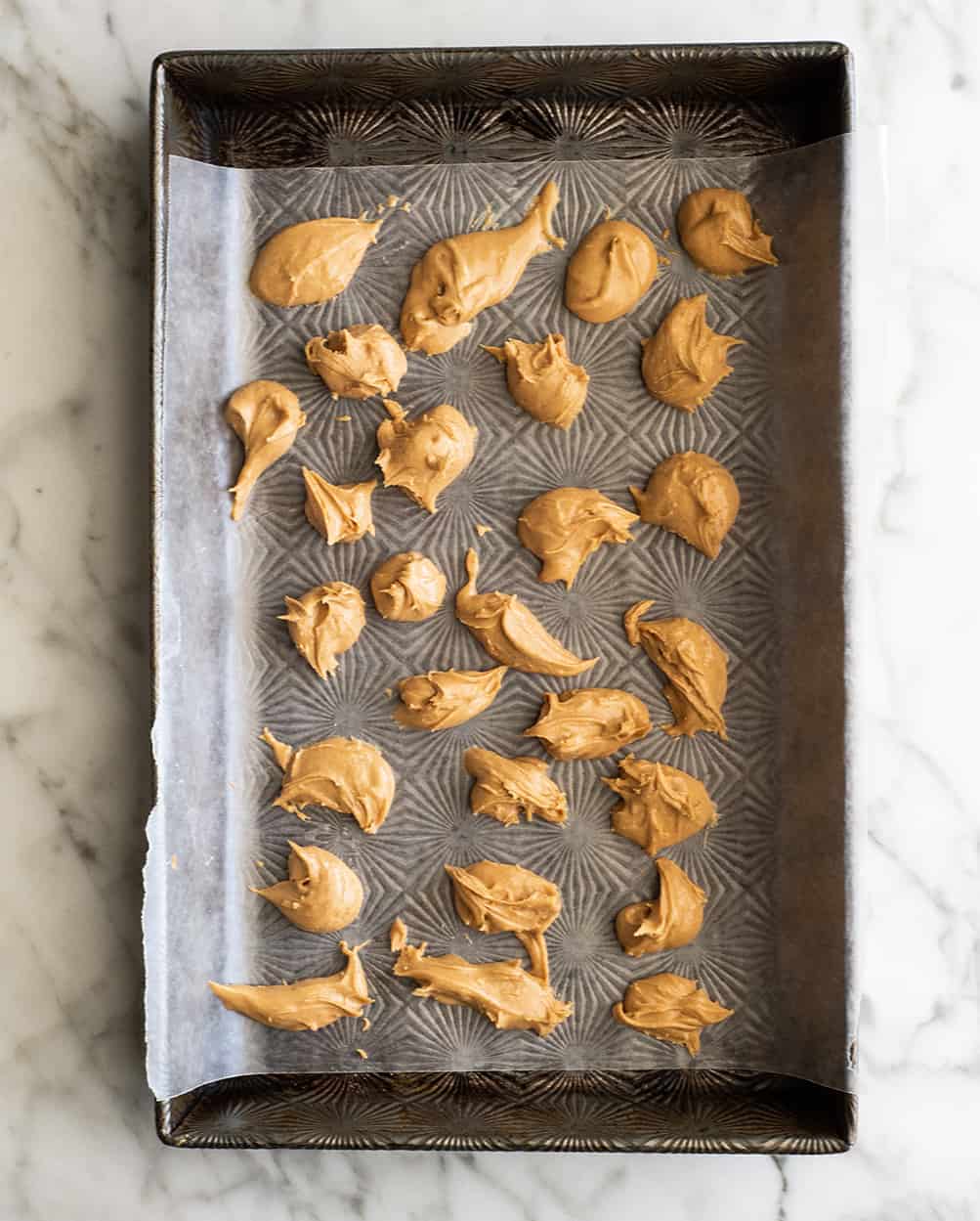 peanut butter chunks on a baking sheet & wax paper to make chocolate peanut butter ice cream