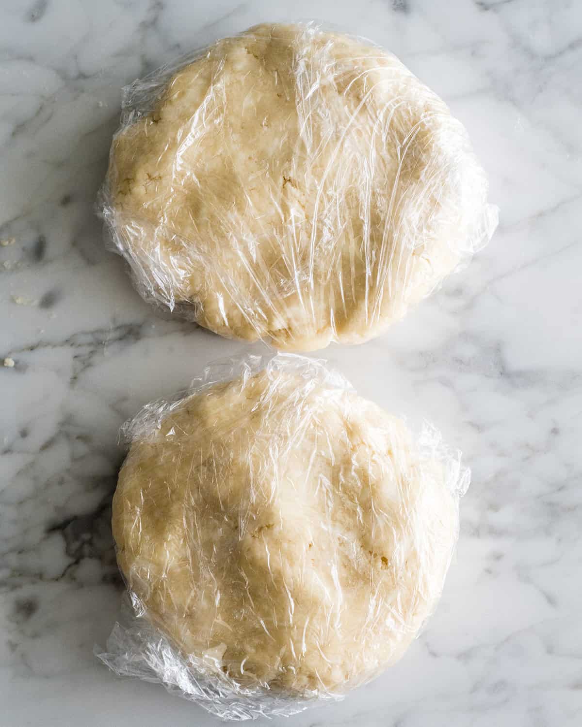two pie crust discs wrapped in plastic wrap to make chicken pot pie
