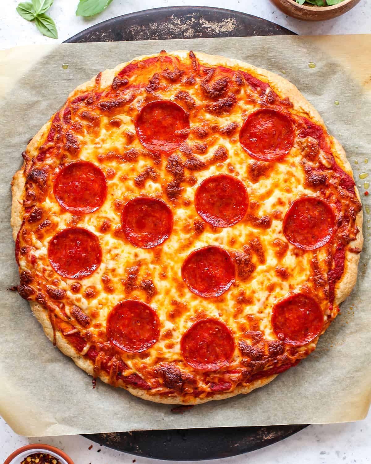 overhead photo of whole wheat pizza crust with toppings baked