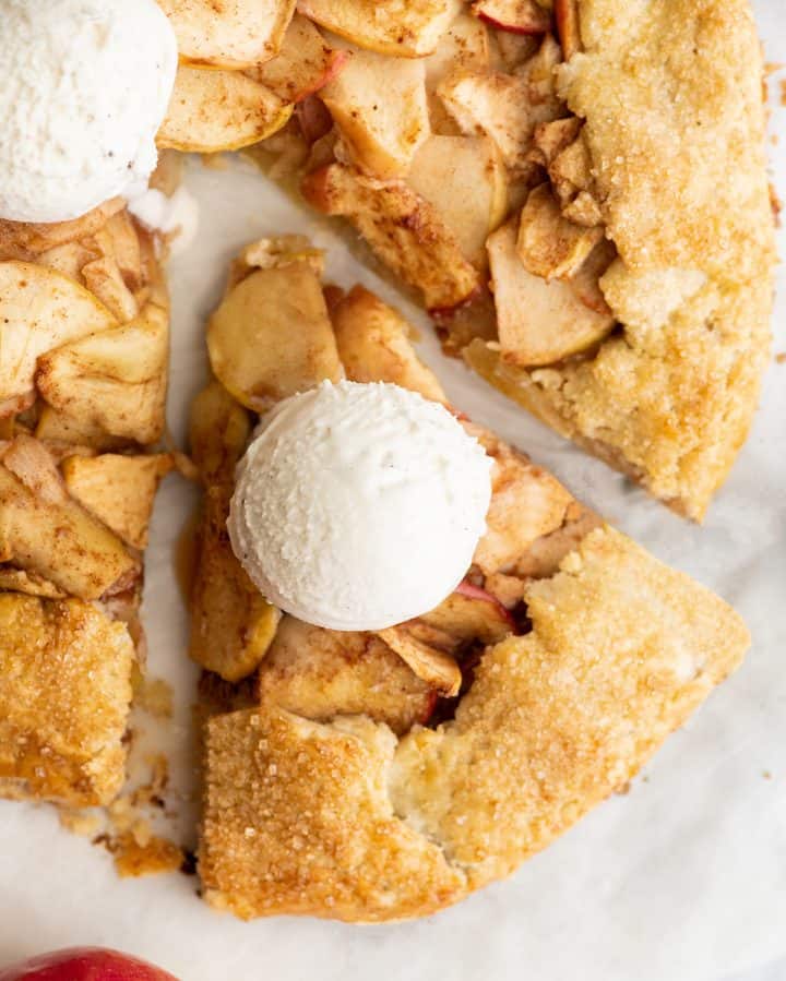 overhead view of a slice of apple galette with ice cream on top