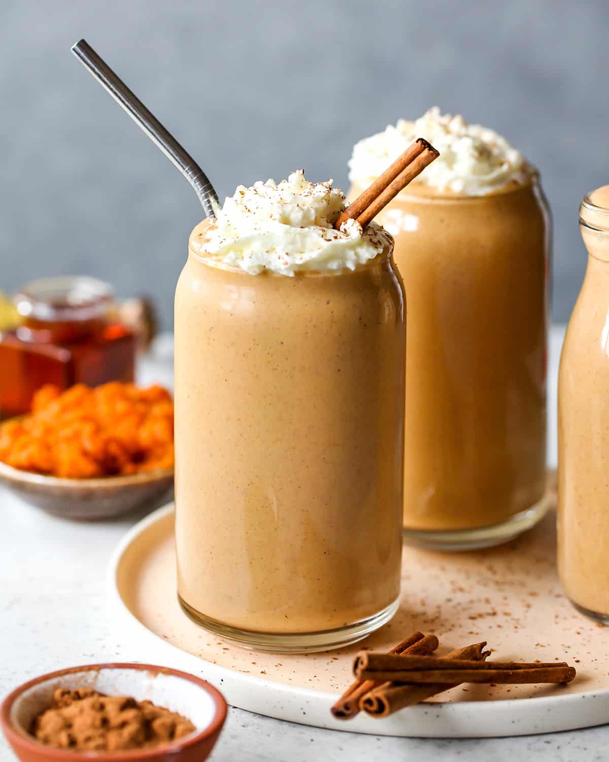pumpkin pie smoothie in a glass with whipped cream
