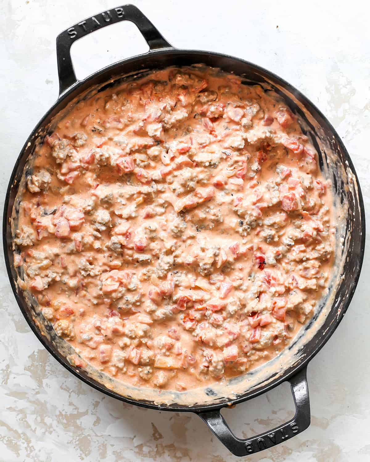making sausage cream cheese dip - dip mixed together after cream cheese has melted in a black cast iron skillet
