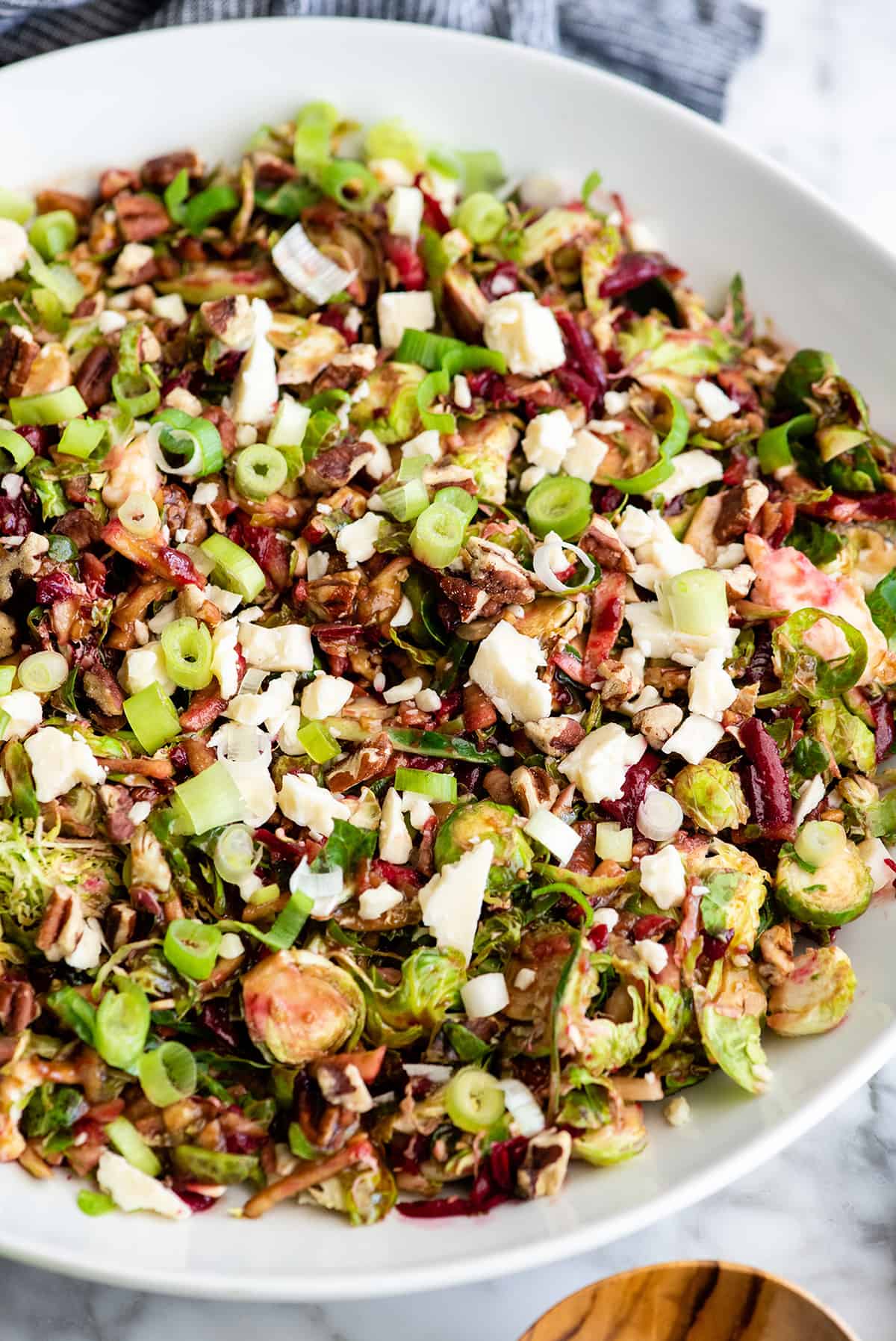 overhead view of Brussel Sprouts Salad in a large white serving bowl