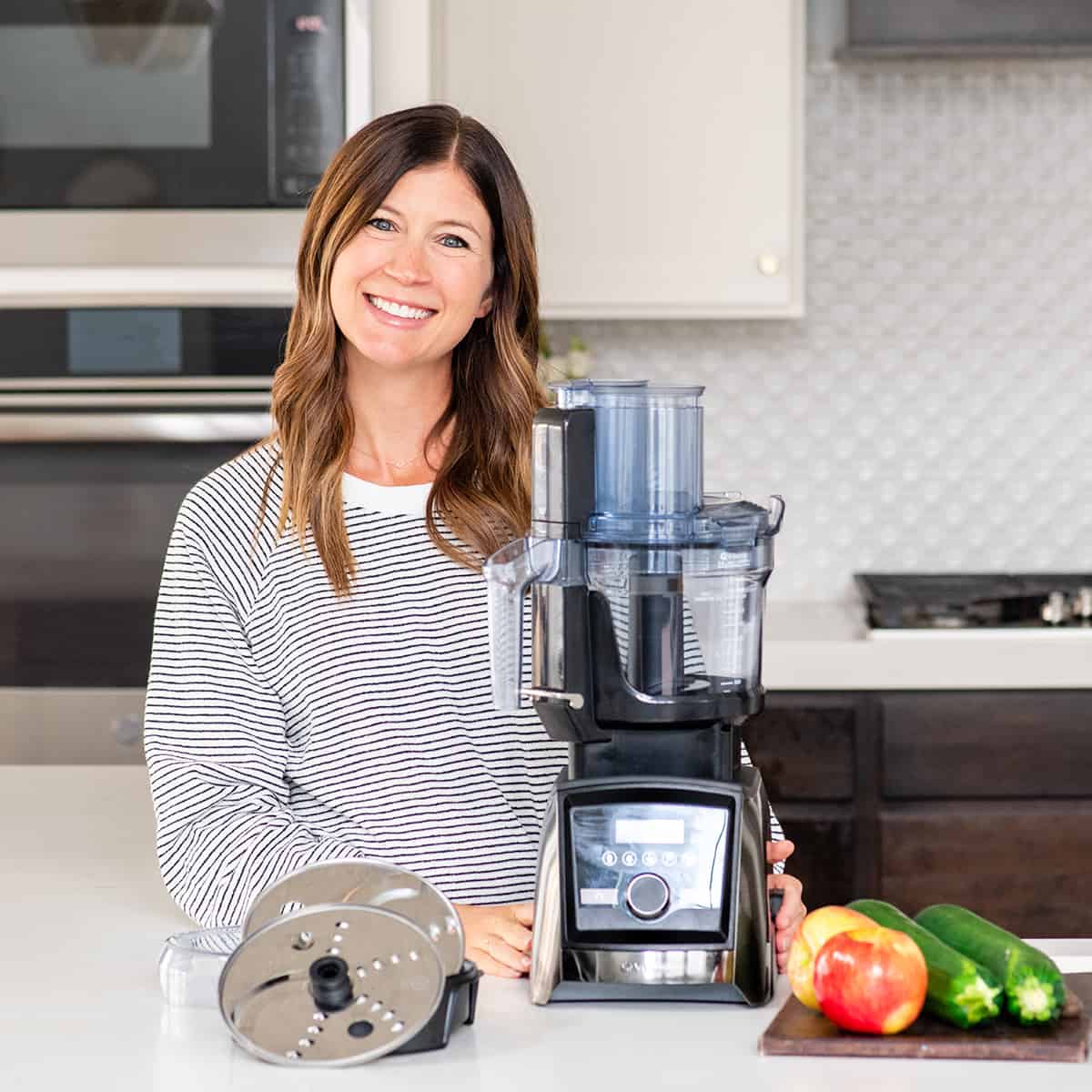 woman smiling near the Vitamix food processor 