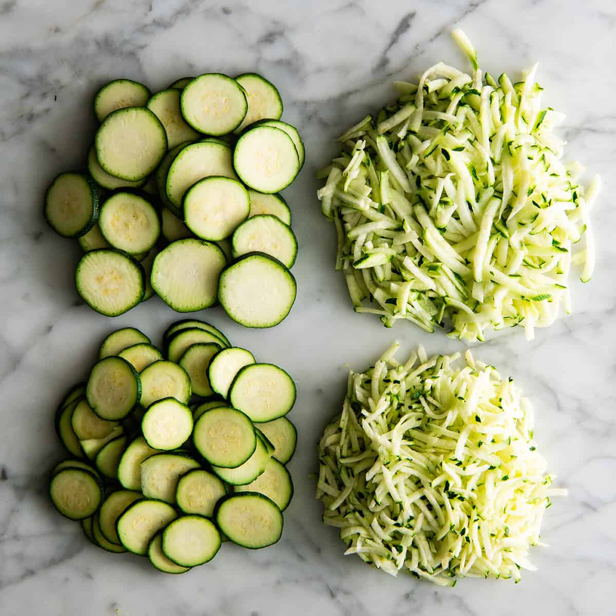 overhead view of zucchini sliced and shredded 4 ways with the Vitamix food processor