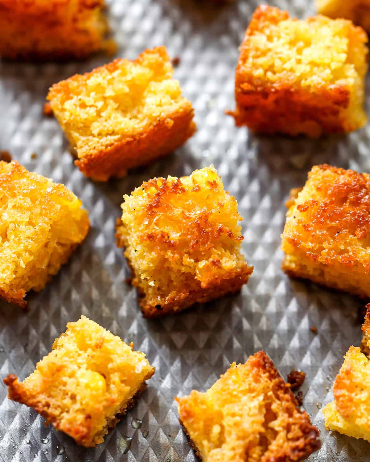 up-close overhead view of Cornbread Croutons on a baking sheet