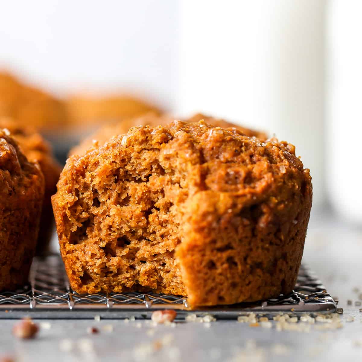front view of a Healthy Pumpkin Muffin with a bite taken out of it