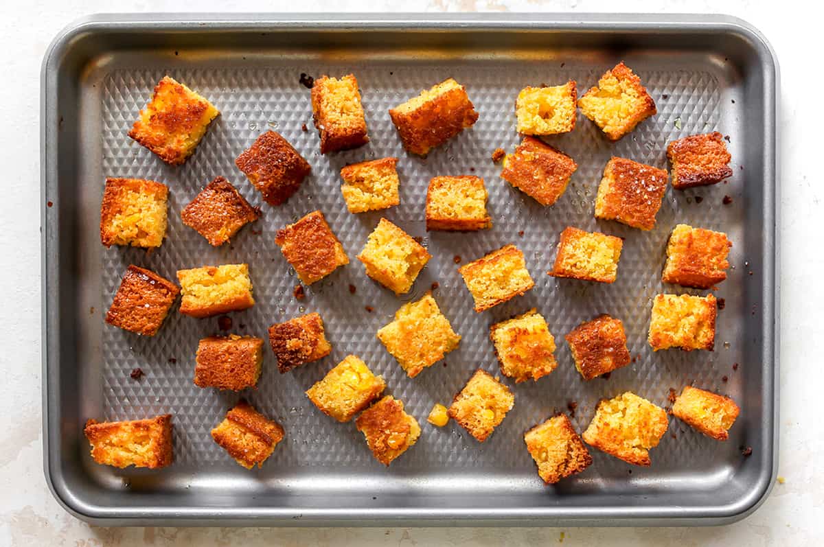 overhead photo of Cornbread Croutons on a baking sheet after being baked