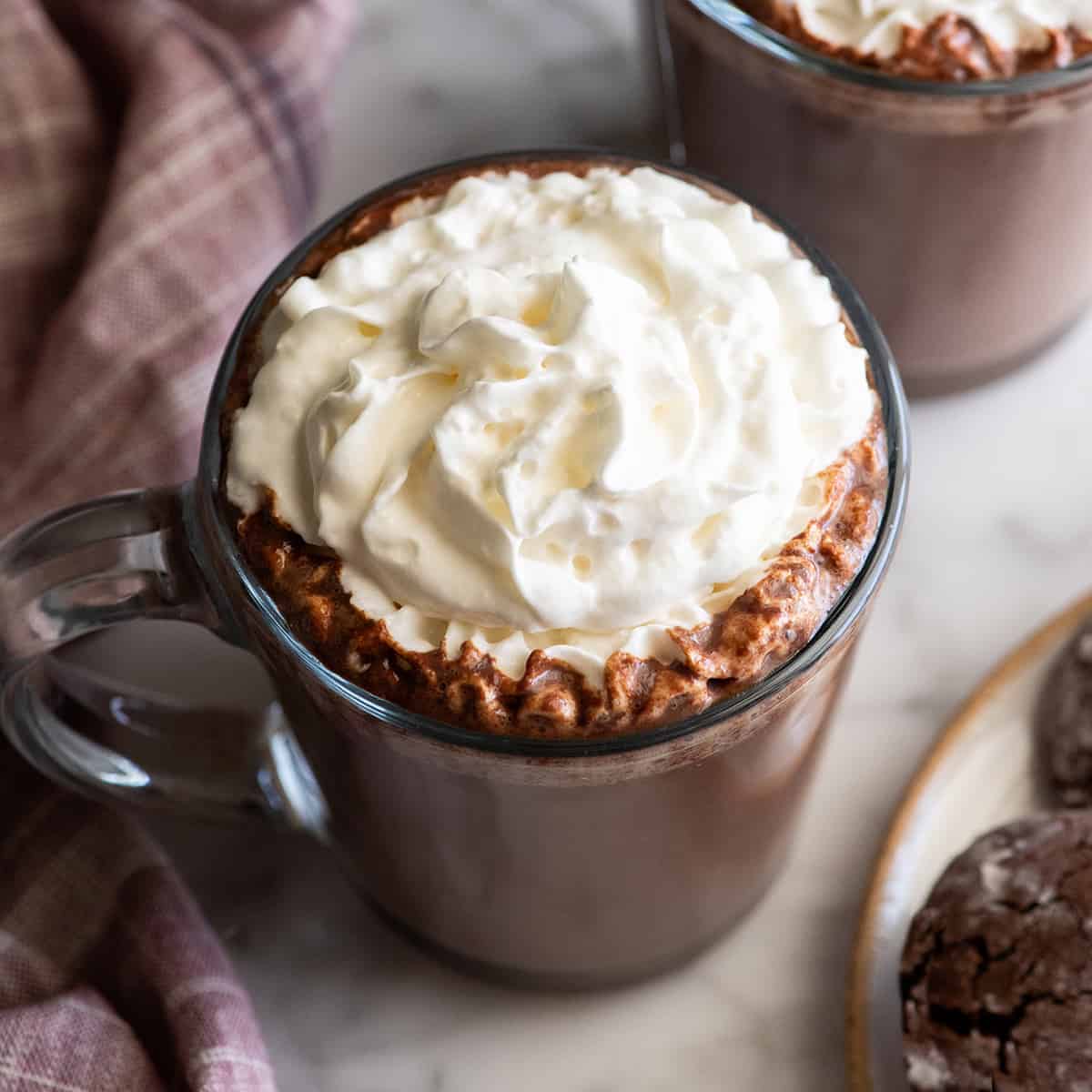 overhead view of a mug of hot cocoa with whipped cream on top