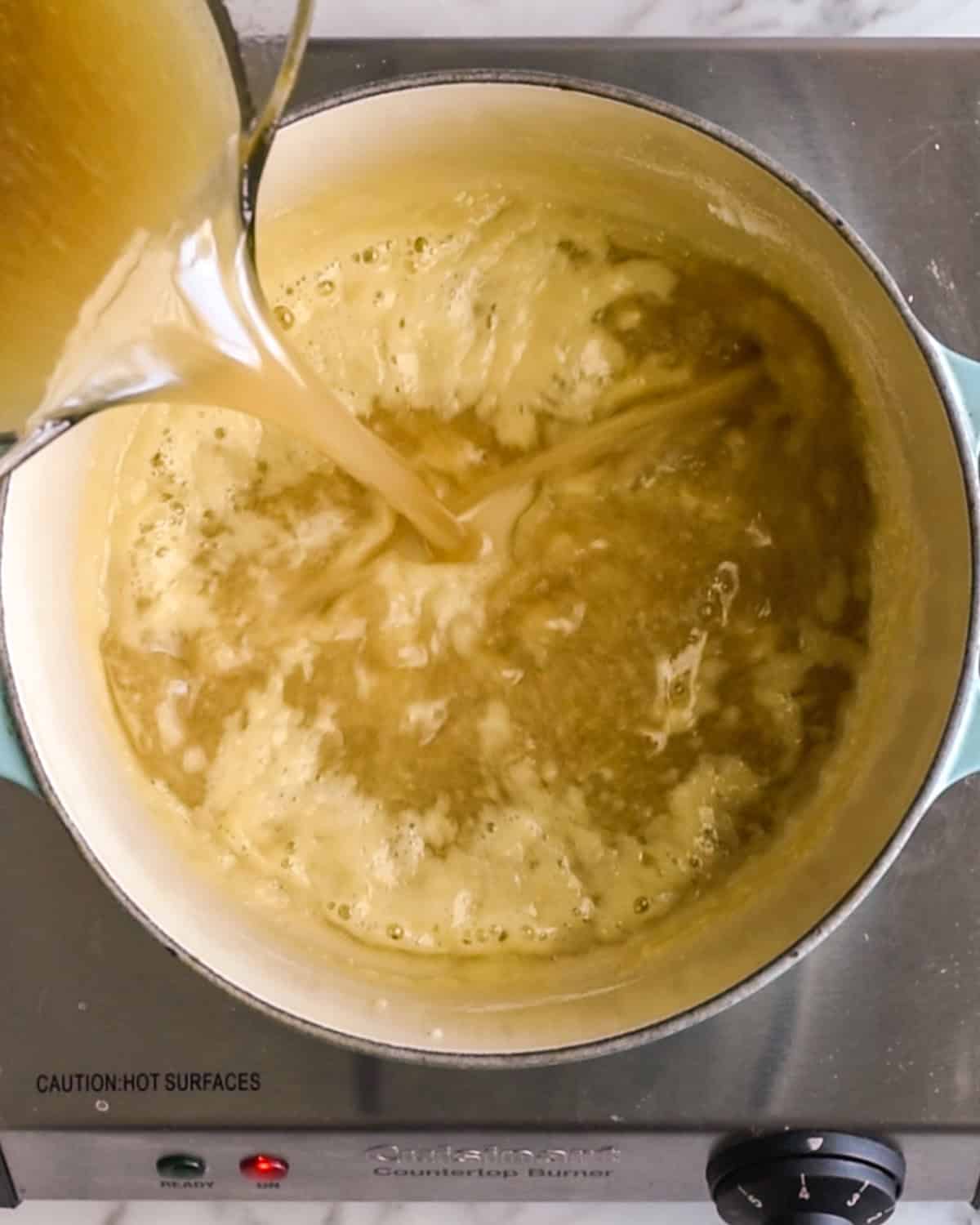 How to make Turkey Gravy with Drippings - pouring drippings into the roux