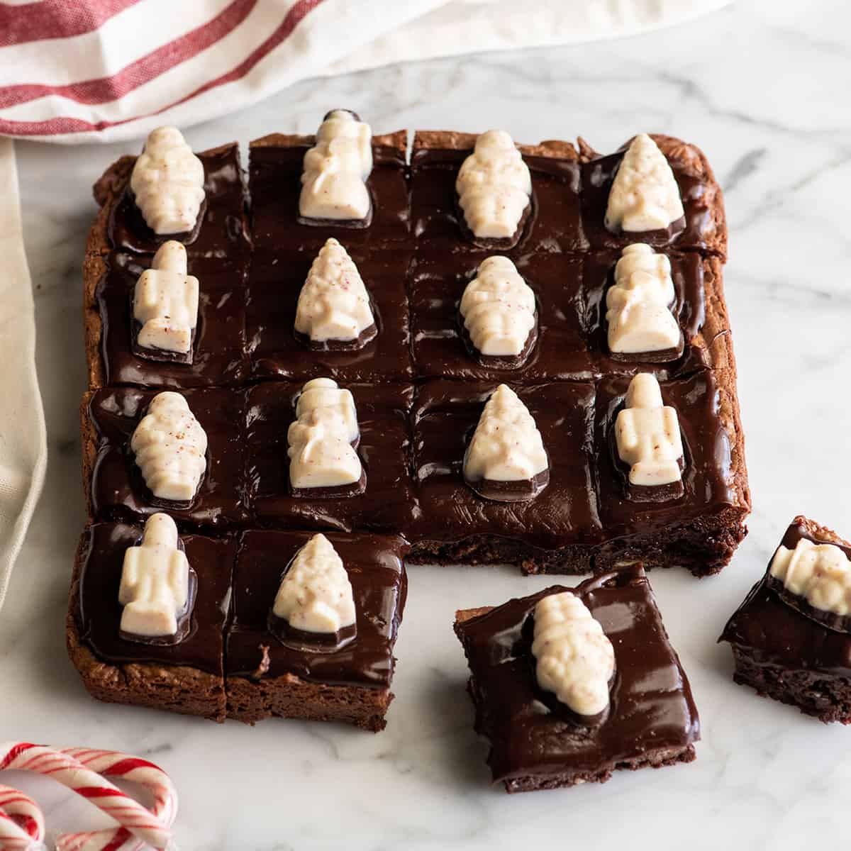 16 Peppermint Brownies with peppermint bark candies on top