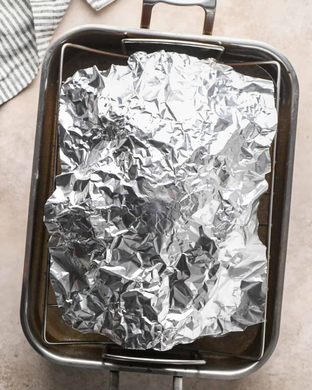 oven roasted turkey in a roasting pan after roasting covered with foil