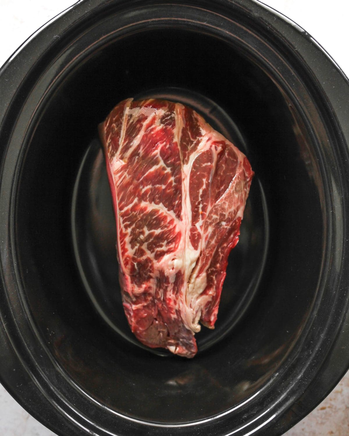 making slow cooker pot roast recipe - roast in a crock pot container