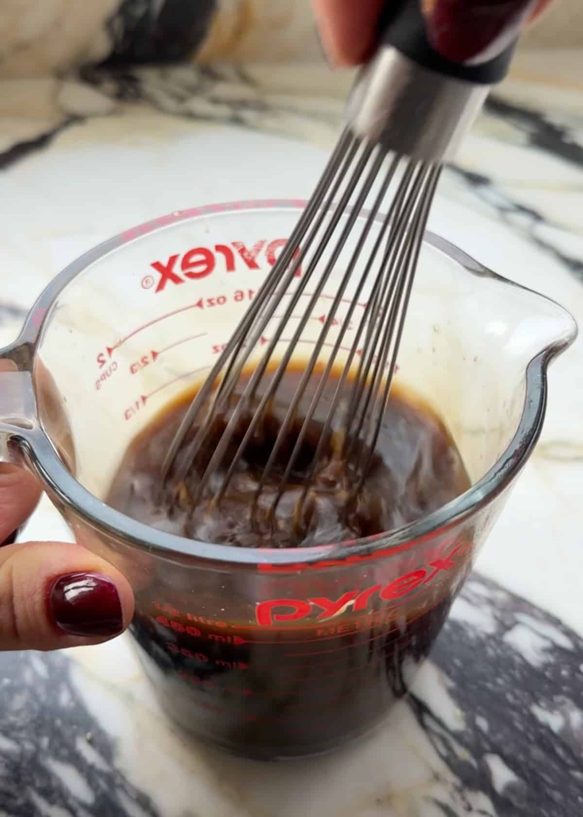 making slow cooker pot roast recipe - whisking the sauce together in a small pyrex measuring cup
