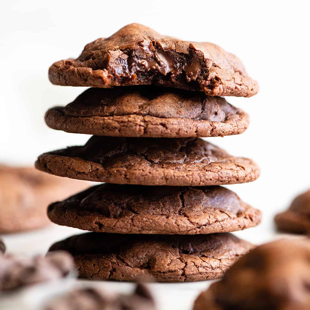 front view of a stack fo 5 Chocolate Brownie Cookies, the top one has a bite taken out of it
