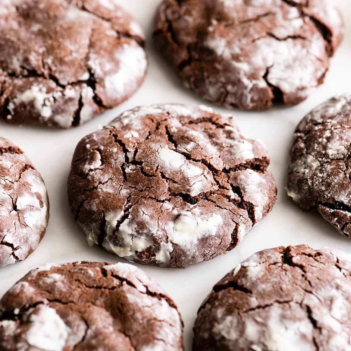 7 Chocolate Crinkle Cookies on a white surface