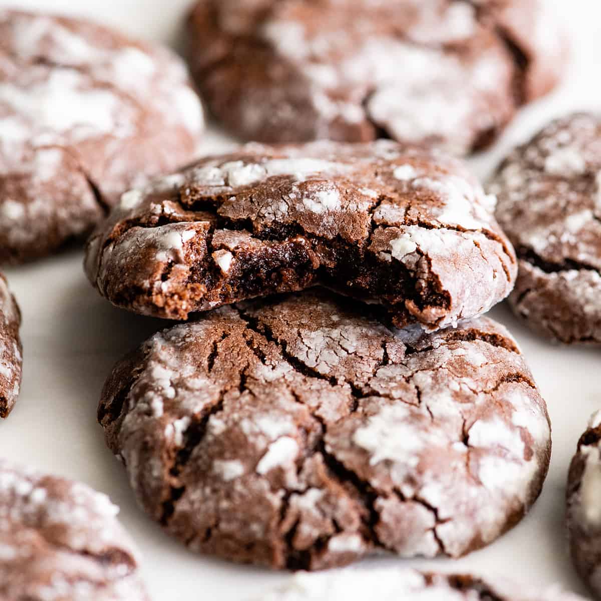 front view of a Chocolate Crinkle Cookie with a bite taken out of it