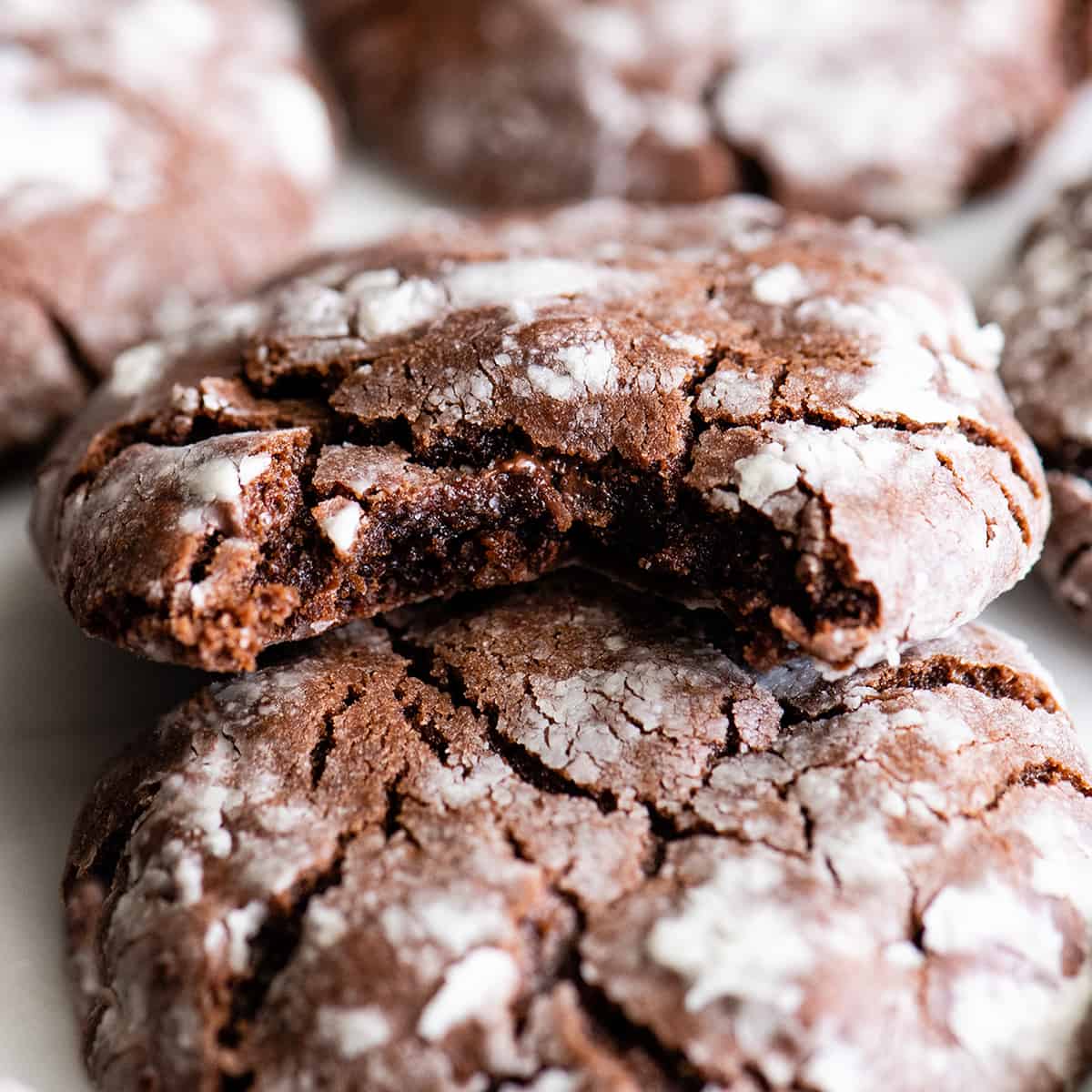 up close front view of a Chocolate Crinkle Cookie with a bite taken out of it