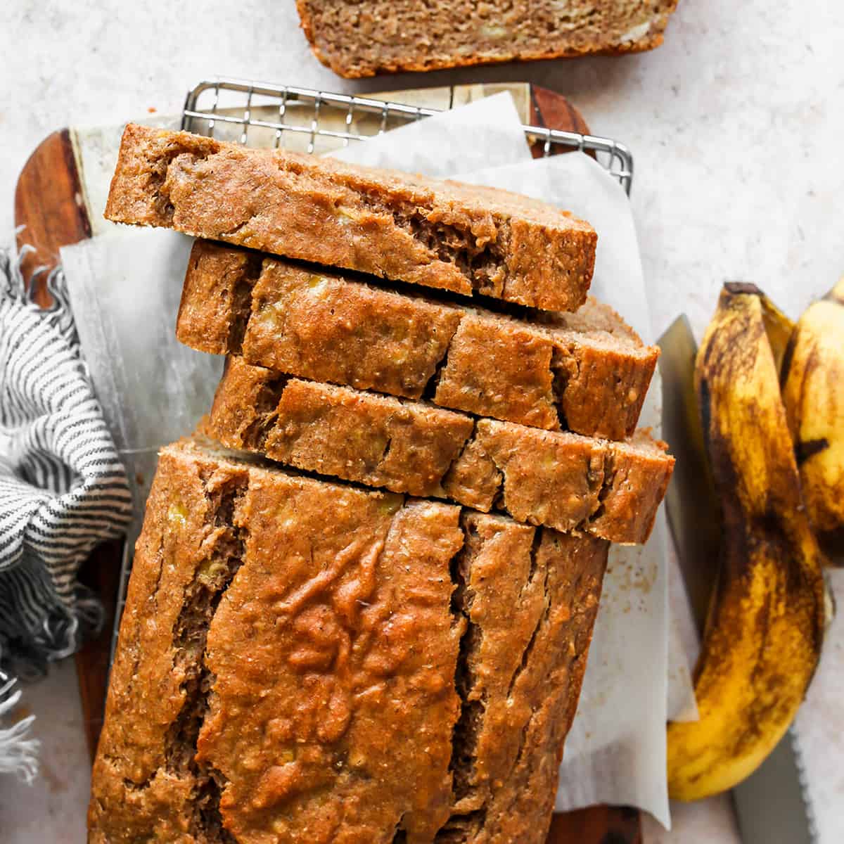 overhead view of a loaf of Healthy Banana Bread with 3 slices cut out