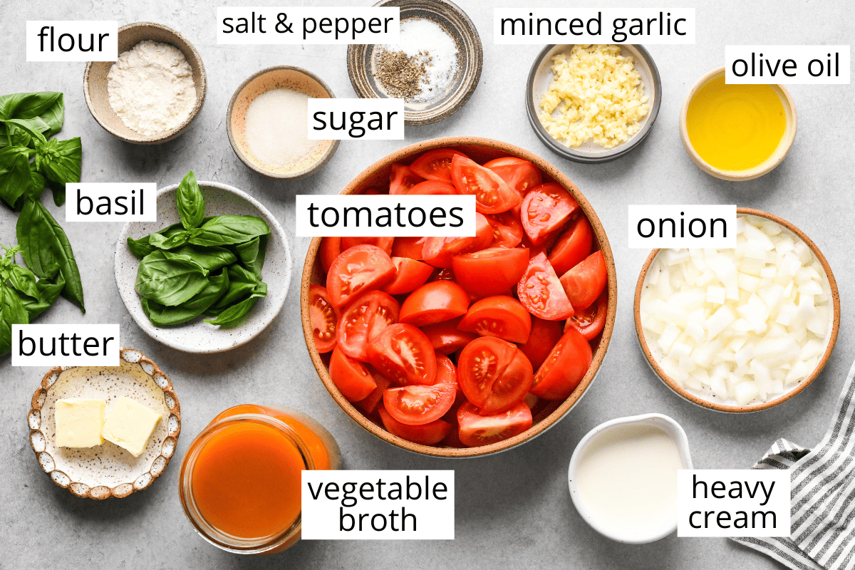 the labeled ingredients in this homemade tomato soup recipe in bowls like tomatoes, onion, basil, vegetable broth, minced garlic and more. 