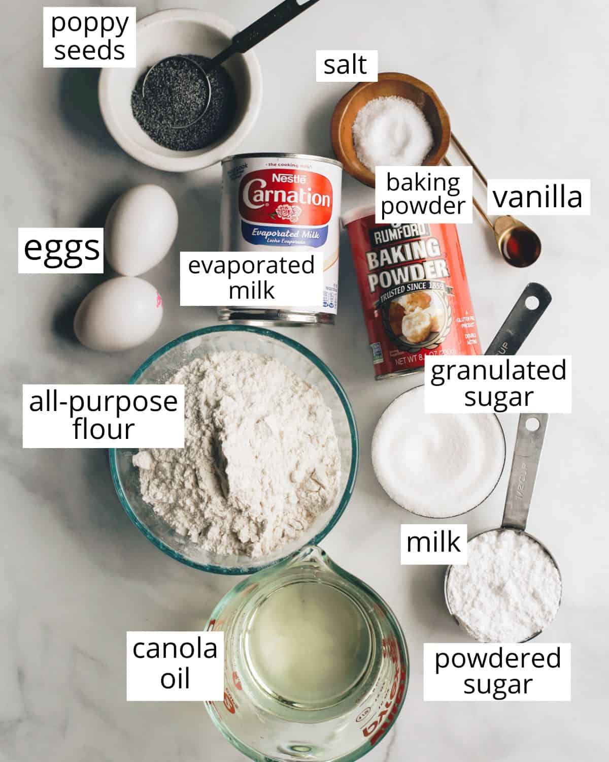overhead photo of the labeled ingredients in this Poppy Seed Cake Recipe