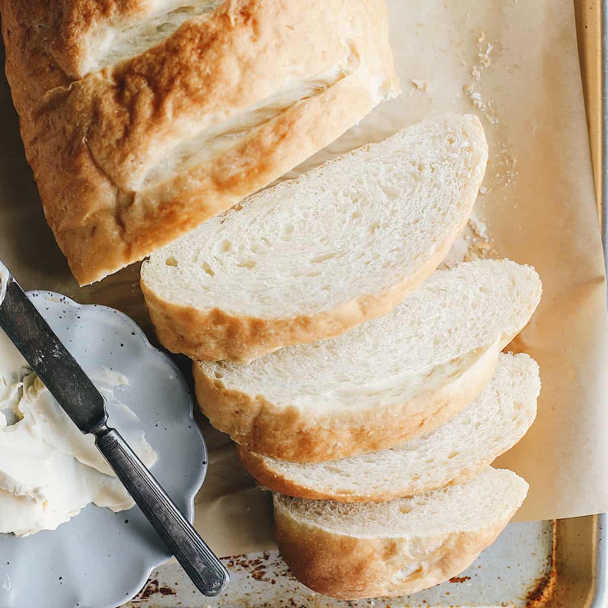 a loaf of french bread with 4 slices cut out of it