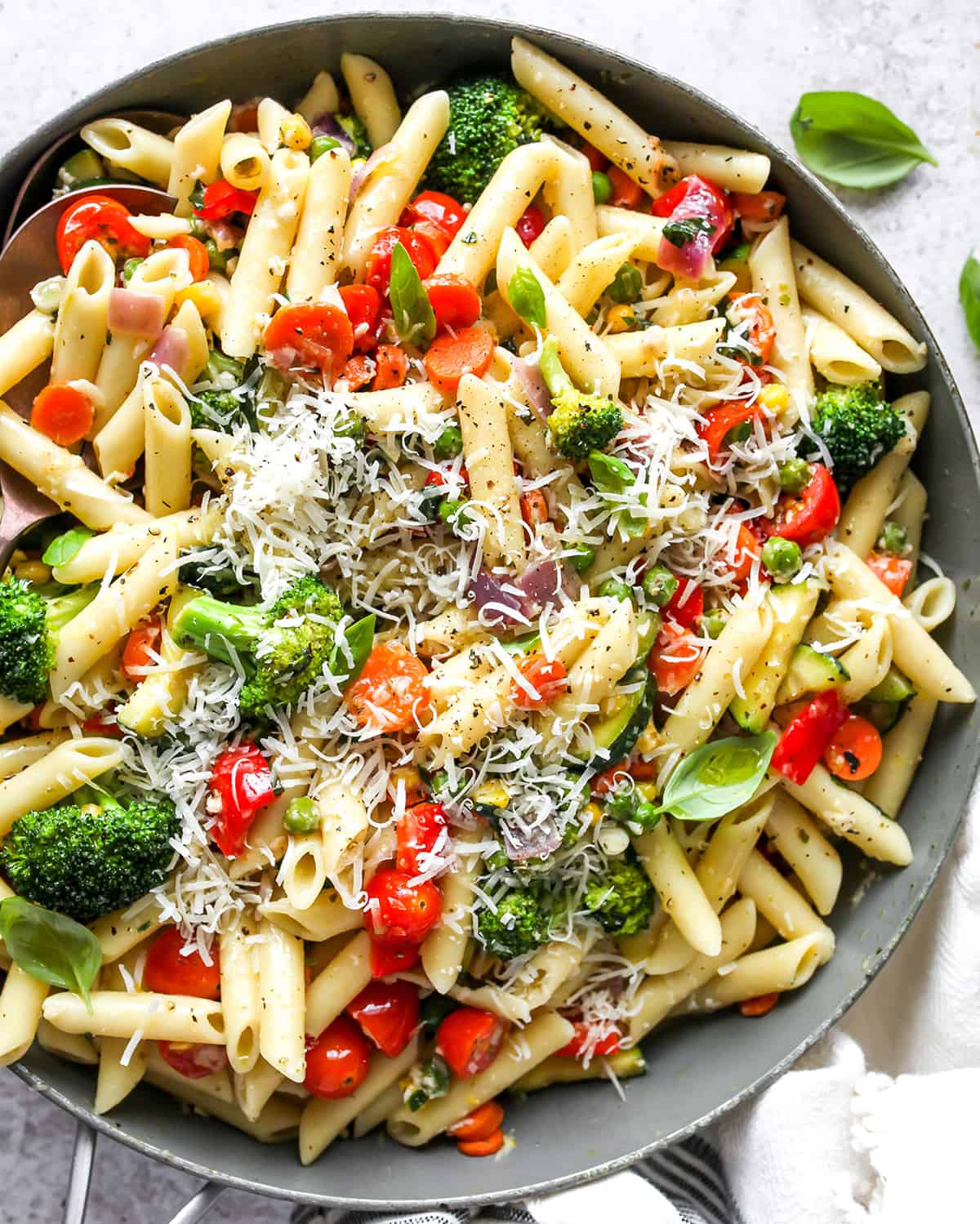 Pasta Primavera Recipe in a pan topped with parmesan cheese