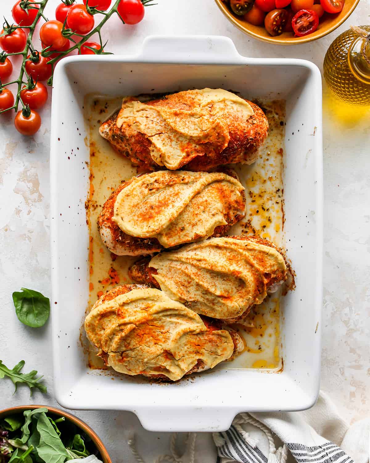 overhead photo of Baked Hummus Chicken in a baking dish