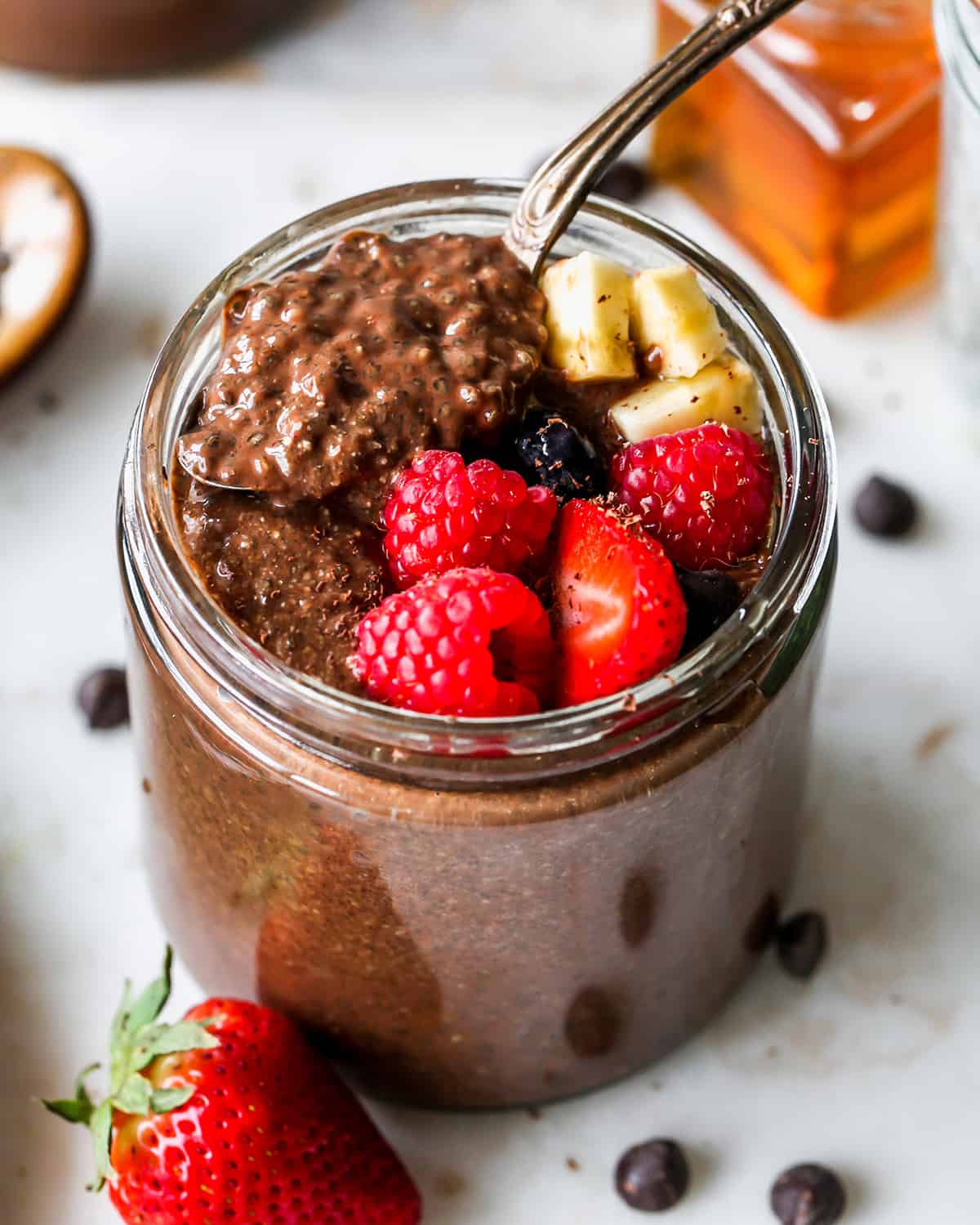 up close photo of a spoon taking a scoop of Chocolate Chia Seed Pudding out of a jar